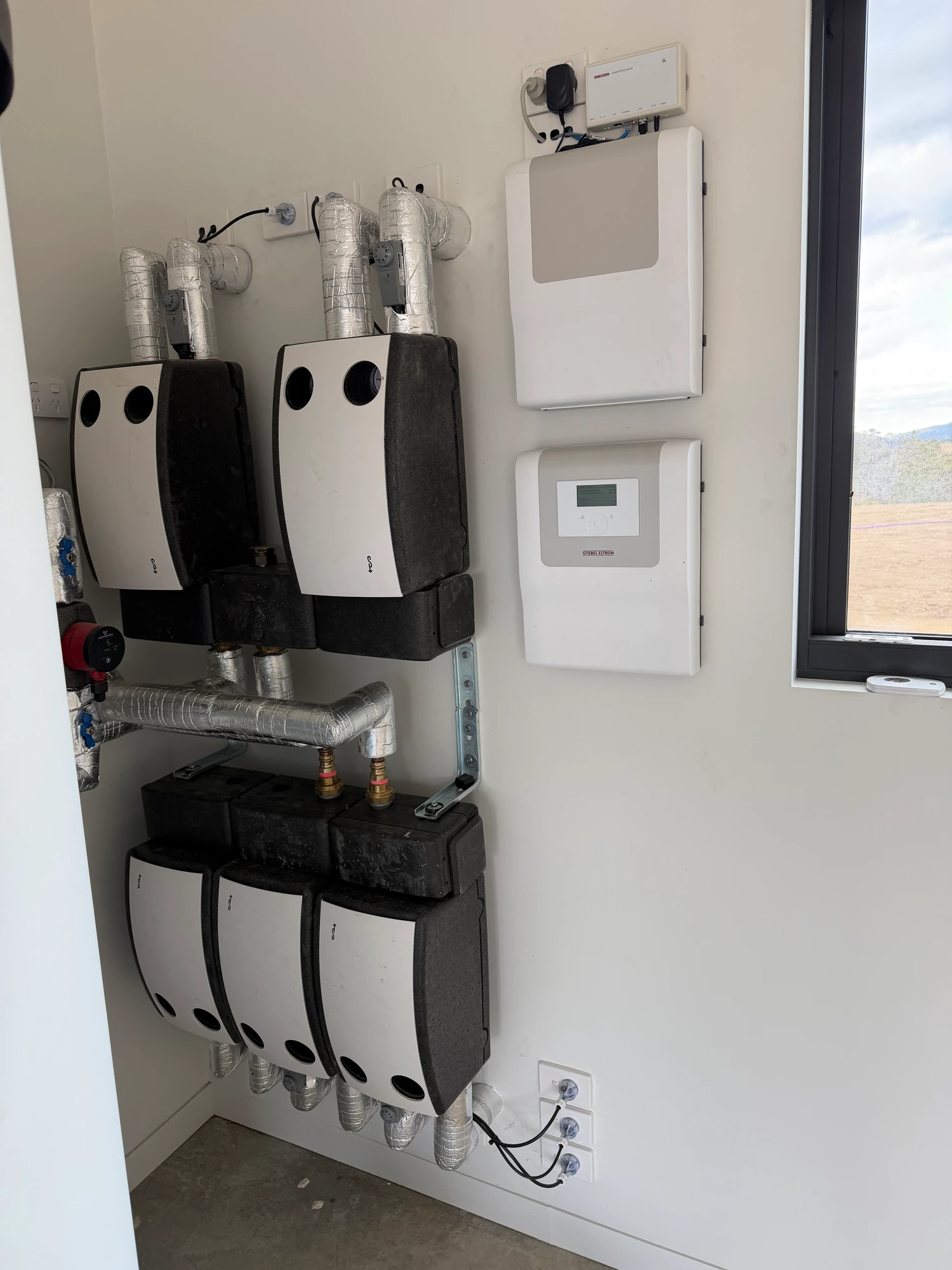Hydronic heating and cooling plant with insulated pipework and system controls